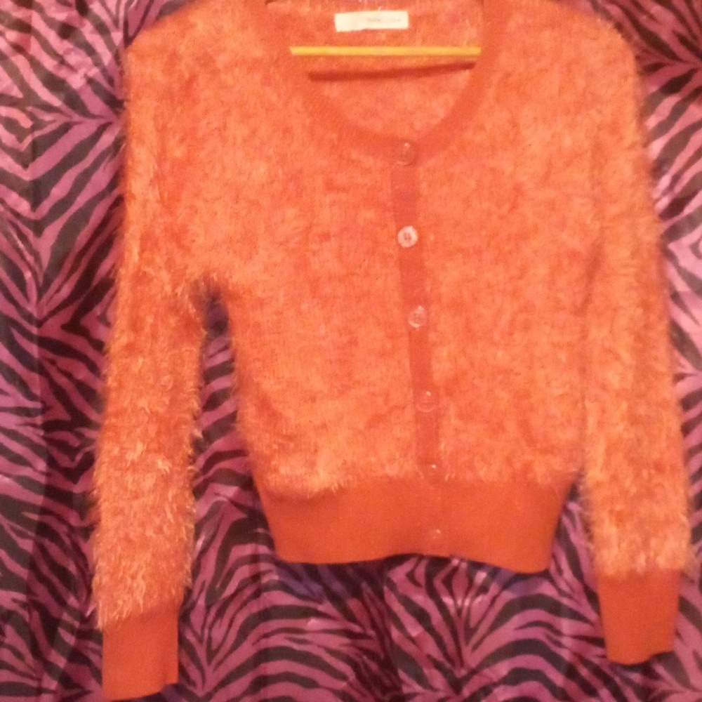 Super soft Med. orange button down cardigan.